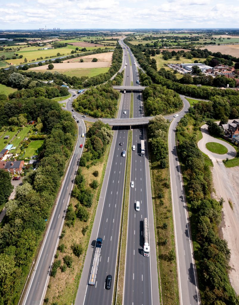 Aerial view above the M62 motorway with roundabout road junction